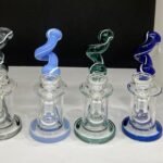 6-inch glass water pipe with a twisted neck design, available in four assorted colors. Durable and compact for a smooth smoking experience.